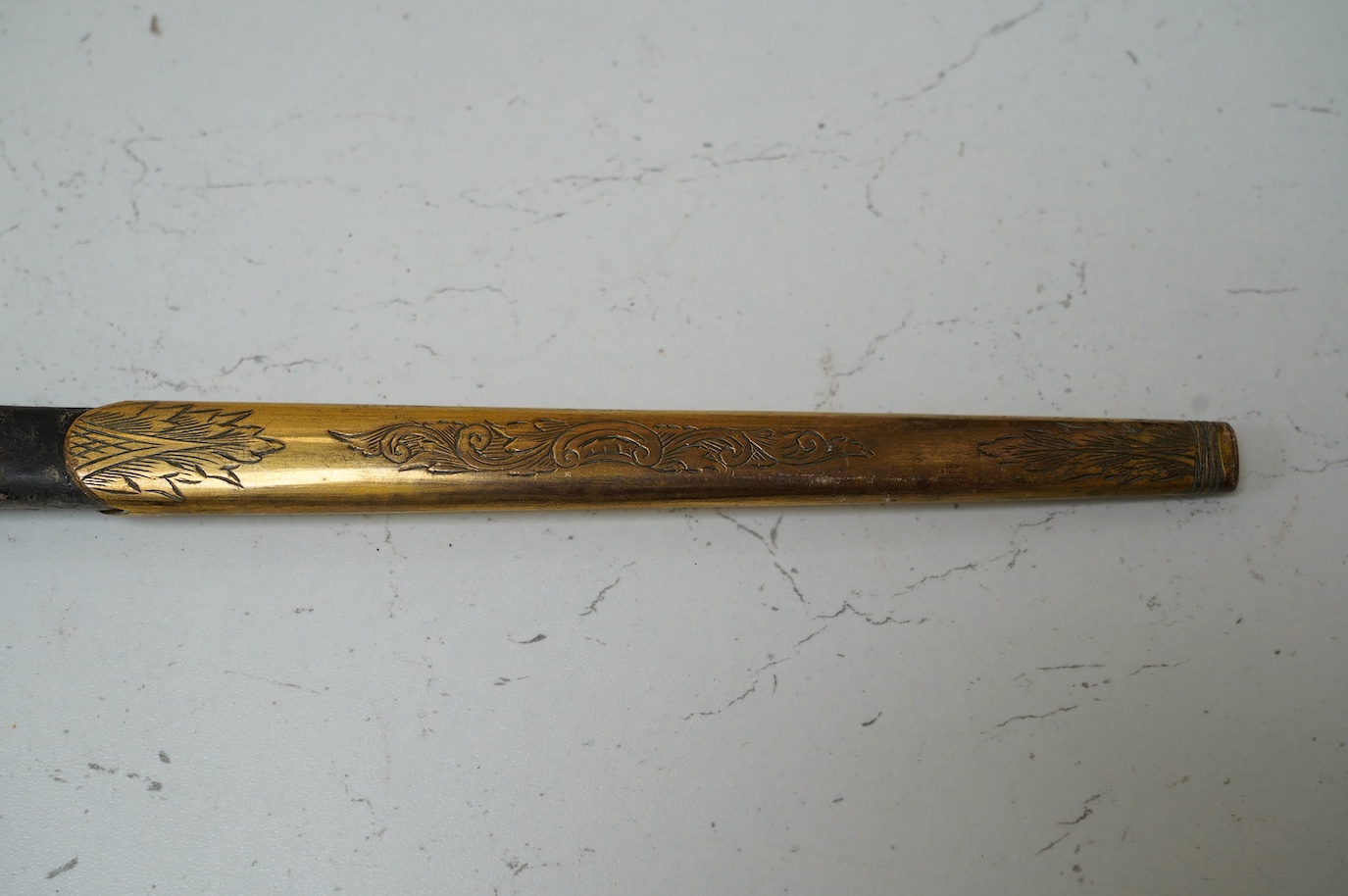 A late Victorian court sword gilt brass hilt with crown on guard, beaded edges, bullion dress knots, in its leather scabbard, blade 78cm. Condition - fair to good